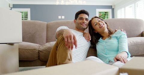 Smiling Couple Relaxing Among Boxes After Moving House - Download Free Stock Images Pikwizard.com