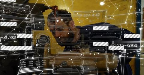 Mechanic in coveralls inspects engine with augmented reality overlay