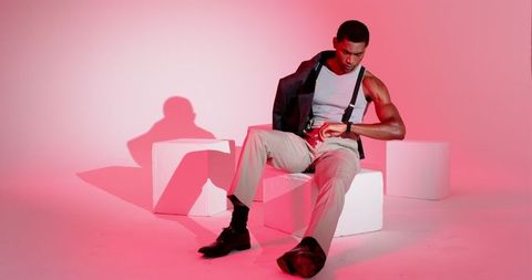 Gentleman Checking Smartwatch in Vivid Red Studio Light