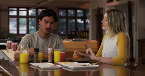 Couple Enjoying Relaxed Breakfast in Modern Kitchen