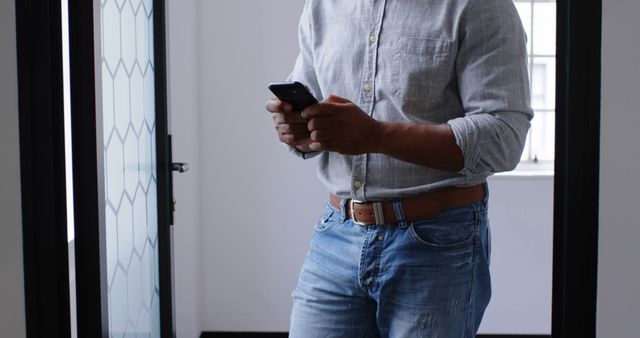 Person texting on smartphone inside modern home - Download Free Stock Images Pikwizard.com