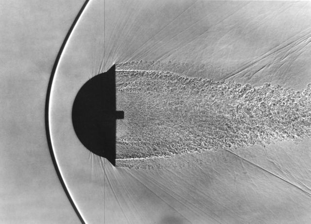 Shadowgraph of Finned Hemispherical model in free-flight show shock waves produced by blunt bodies (H. Julian Allen blunt nose theory) (Used in NASA/AMES publication  'Adventures in Research' A history of Ames Research Center 1940 - 1965 by Edwin P. Hartman - SP-4302)