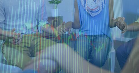 Diverse Group Holding Hands with Financial Data Overlay