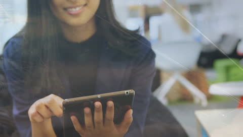 Businesswoman Engaging with Digital Tablet Amid Data Visualization