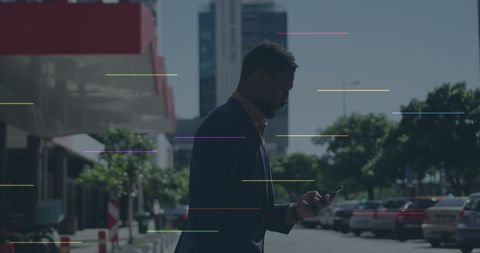 African American Professional Engaged with Social Media Icons on Urban Street