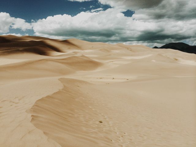Vast Sand Dunes under Dramatic Sky - Download Free Stock Photos Pikwizard.com