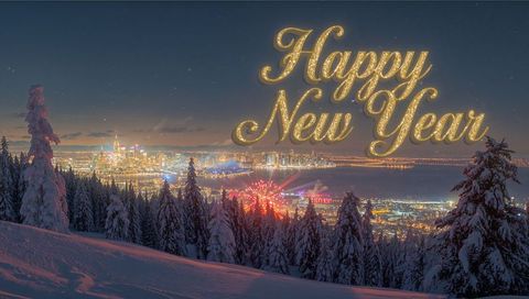Golden happy new year lettering above snowy hillside with city skyline and fireworks