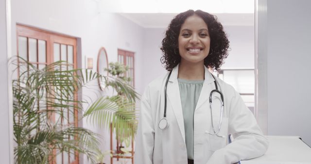 Confident Female Doctor Smiling in Clinical Environment - Download Free Stock Images Pikwizard.com