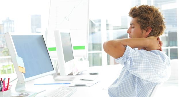 Stressed Businessman Stretching in Office - Download Free Stock Images Pikwizard.com