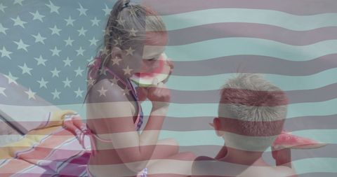 Patriotic summertime: siblings enjoying watermelon at the beach