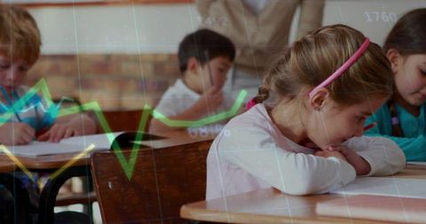Young Schoolchildren Focused on Desk Work in Classroom Environment