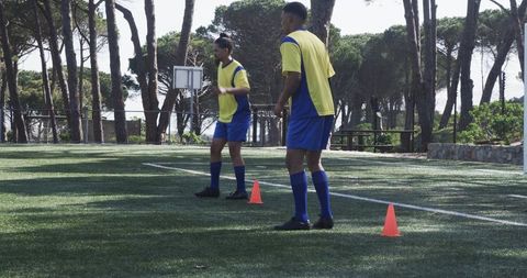 soccer players practicing agility drills on field with cones - Download Free Stock Images Pikwizard.com
