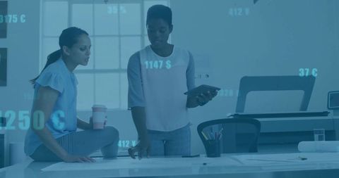 Businesswomen Analyzing Plans in Contemporary Office