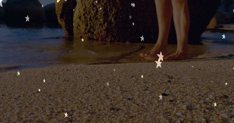 Bare Feet on Serene Pebbly Beach Near Large Rock