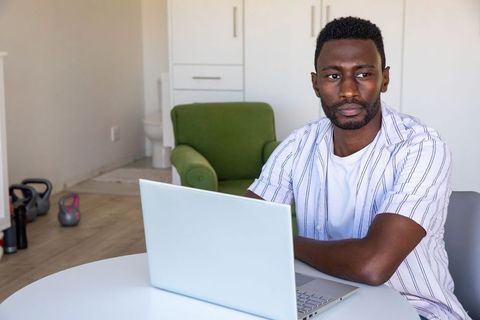 African American Man Working on Laptop in Casual Home Office