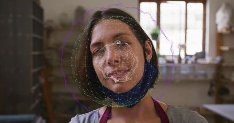 Artisan tilting head for facial tracking calibration with mesh overlay in craft workshop