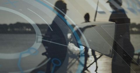 Digitalized sailing team navigating in morning light with hud interface