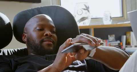 Relaxed Man Browsing Smartwatch in Cozy Living Room - Download Free Stock Images Pikwizard.com