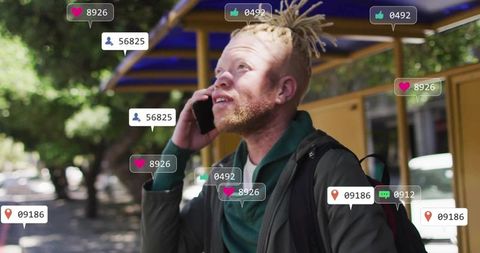 Man with Dreadlocks Communicating via Smartphone with Social Media Overlays