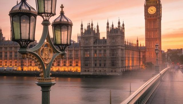 Victorian lamppost on westminster bridge at sunset with parliament and elizabeth tower