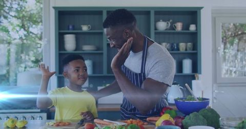 Father and Son Bonding in Kitchen Preparing Healthy Meal