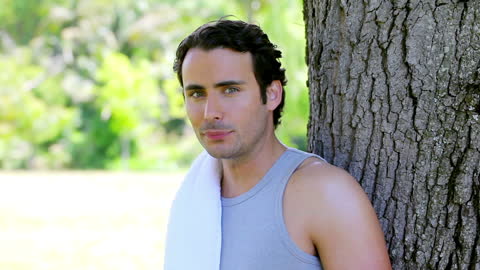 Man Relaxing Outdoors with Towel After Exercise
