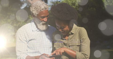 Outdoor African American Couple Engaged with Smartphone