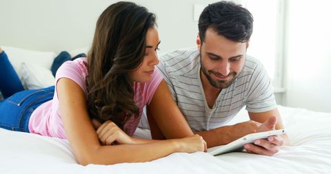 Couple Relaxing Together with Tablet in Bedroom - Download Free Stock Images Pikwizard.com