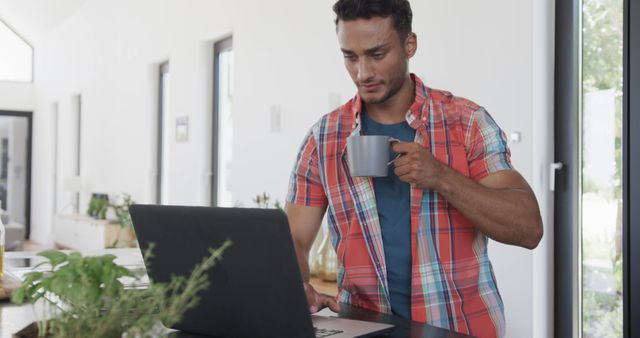 Man Drinking Coffee While Working on Laptop in Modern Home Office - Download Free Stock Images Pikwizard.com