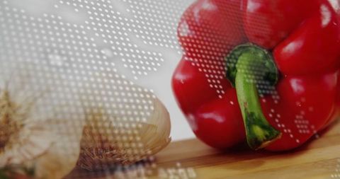 World map and fresh produce: red bell pepper and garlic on wooden board