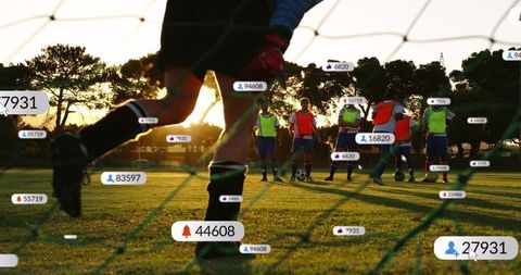 Goalkeeper Kicking Soccer Ball with Social Icons at Sunset