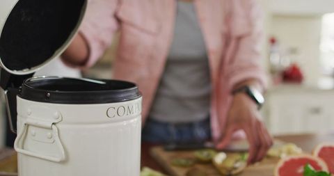 Woman Composting Kitchen Waste for Eco-friendly Living