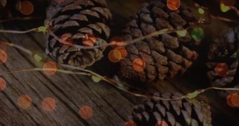 Rustic Wooden Surface with Pine Cones and Festive LED String Lights - Download Free Stock Images Pikwizard.com