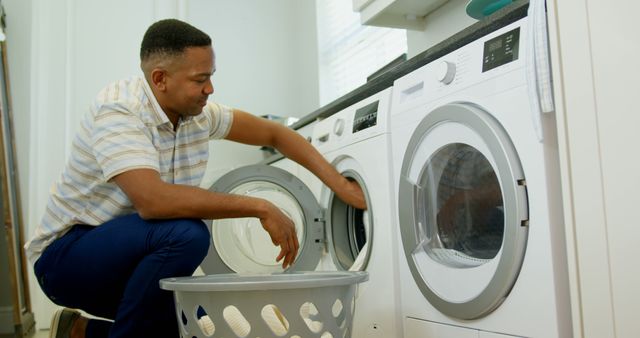 Man Doing Laundry at Home with Washing Machine - Download Free Stock Photos Pikwizard.com
