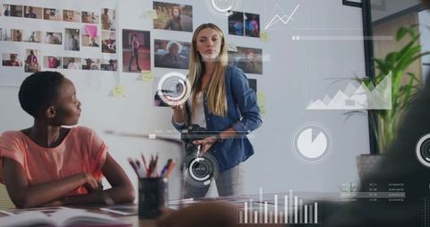 Photographer pointing and collaborating over moodboard with team, studio brainstorming