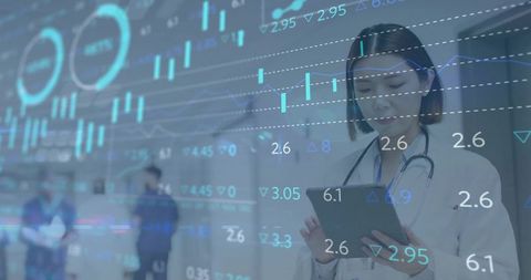Female physician checking tablet with data-driven overlay in hospital corridor health tech