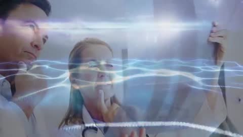 Doctors Analyzing X-ray with Futuristic Holographic Waves