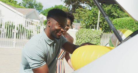 Happy family packing car for a holiday adventure