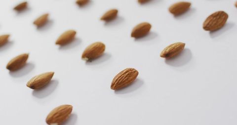 Almonds arranged on white background for plant-based diet concept