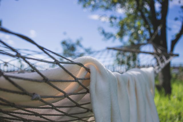 Brown Hammock With Towel Near Trees - Download Free Stock Photos Pikwizard.com