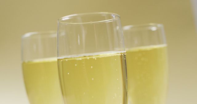 Image of champagne in glasses on yellow background. alcohol, beverage, drinks, party and celebration concept.