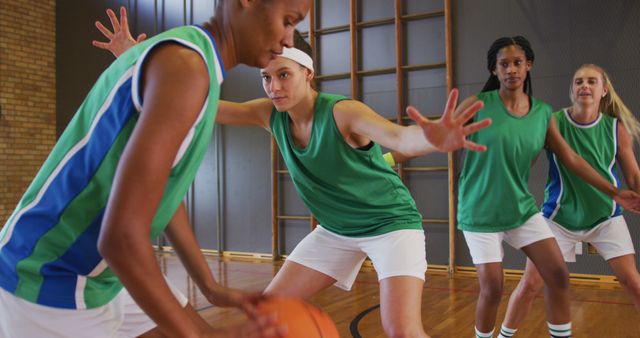 Diverse female basketball team playing match, dribbling and shooting ball - Download Free Stock Photos Pikwizard.com