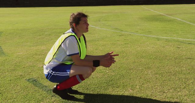 Soccer Player Resting on Field in Bright Sunlight - Download Free Stock Images Pikwizard.com