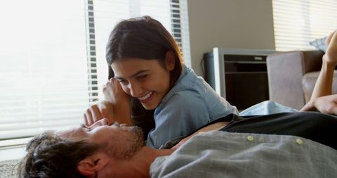 Happy Interracial Couple Sharing Intimate Moment at Home