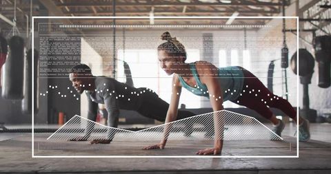 Dynamic partner plank workout in industrial gym with futuristic data hud overlay