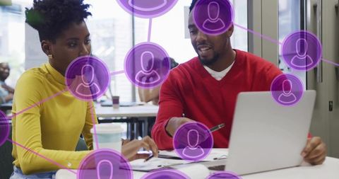 Team collaborating at laptop in bright modern coworking office with purple network overlay