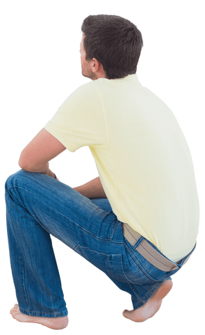 Man in casual outfit crouching, looking up isolated on transparent background