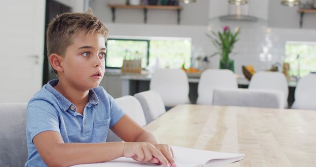 Curious Child Reading Book in Bright Modern Kitchen - Download Free Stock Images Pikwizard.com