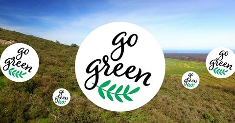 Floating go green logos over lush hillside promoting sustainability