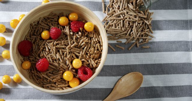 Healthy Breakfast Cereal with Raspberries and Yellow Berries on Striped Tablecloth - Download Free Stock Images Pikwizard.com